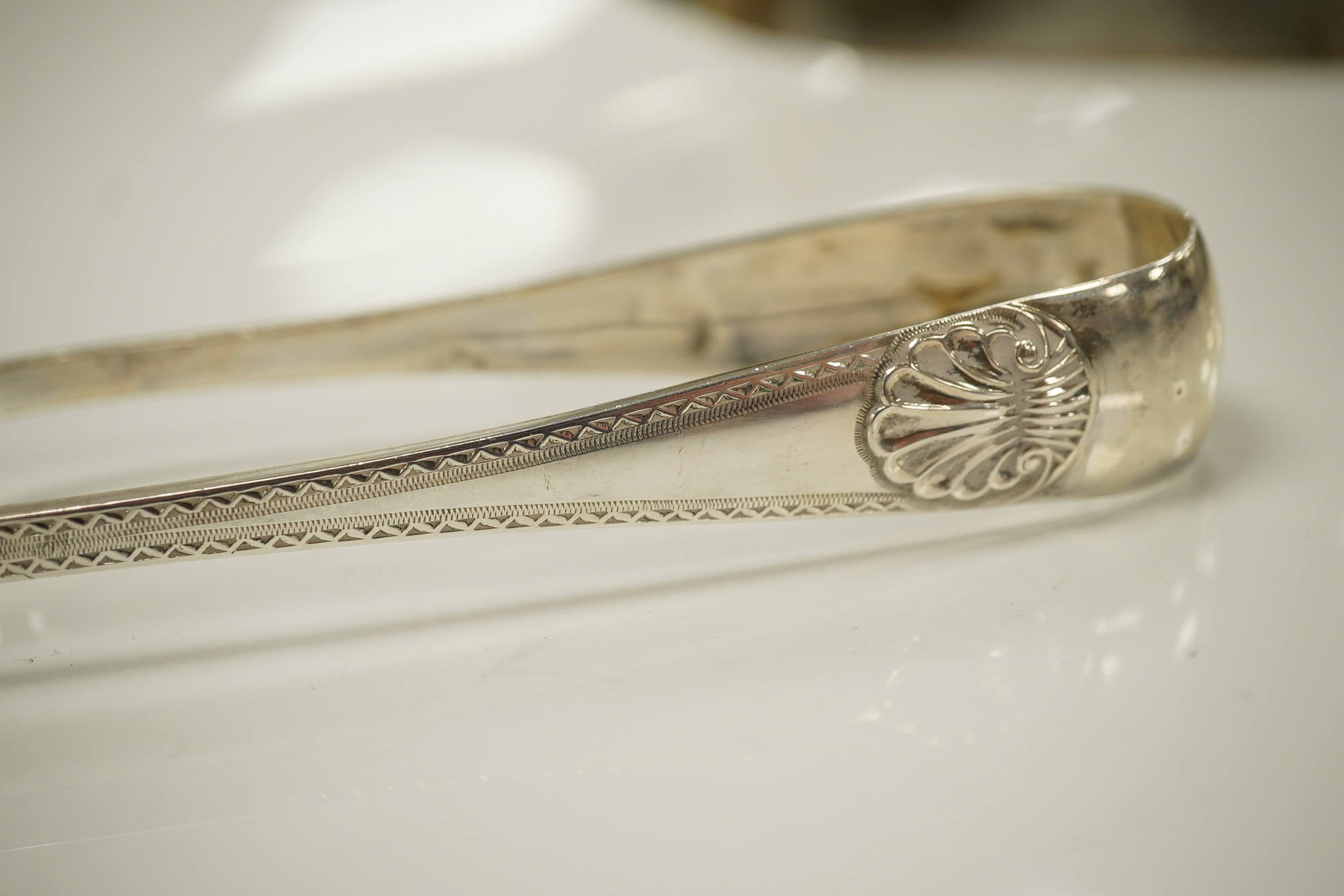 A pair of late Victorian silver bright cut shell pattern asparagus tongs, by George Howson, Sheffield, 1897, 23.2cm, 5.1oz. Condition - good